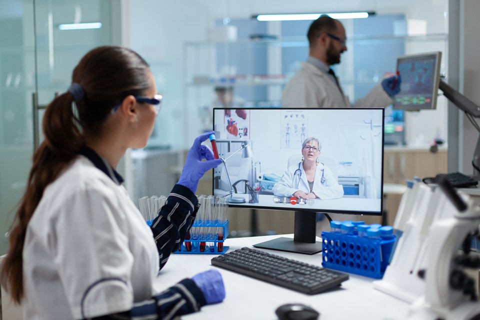 biologist-researcher-woman-holding-blood-test-tube-in-hands-discussing-medical-vaccine