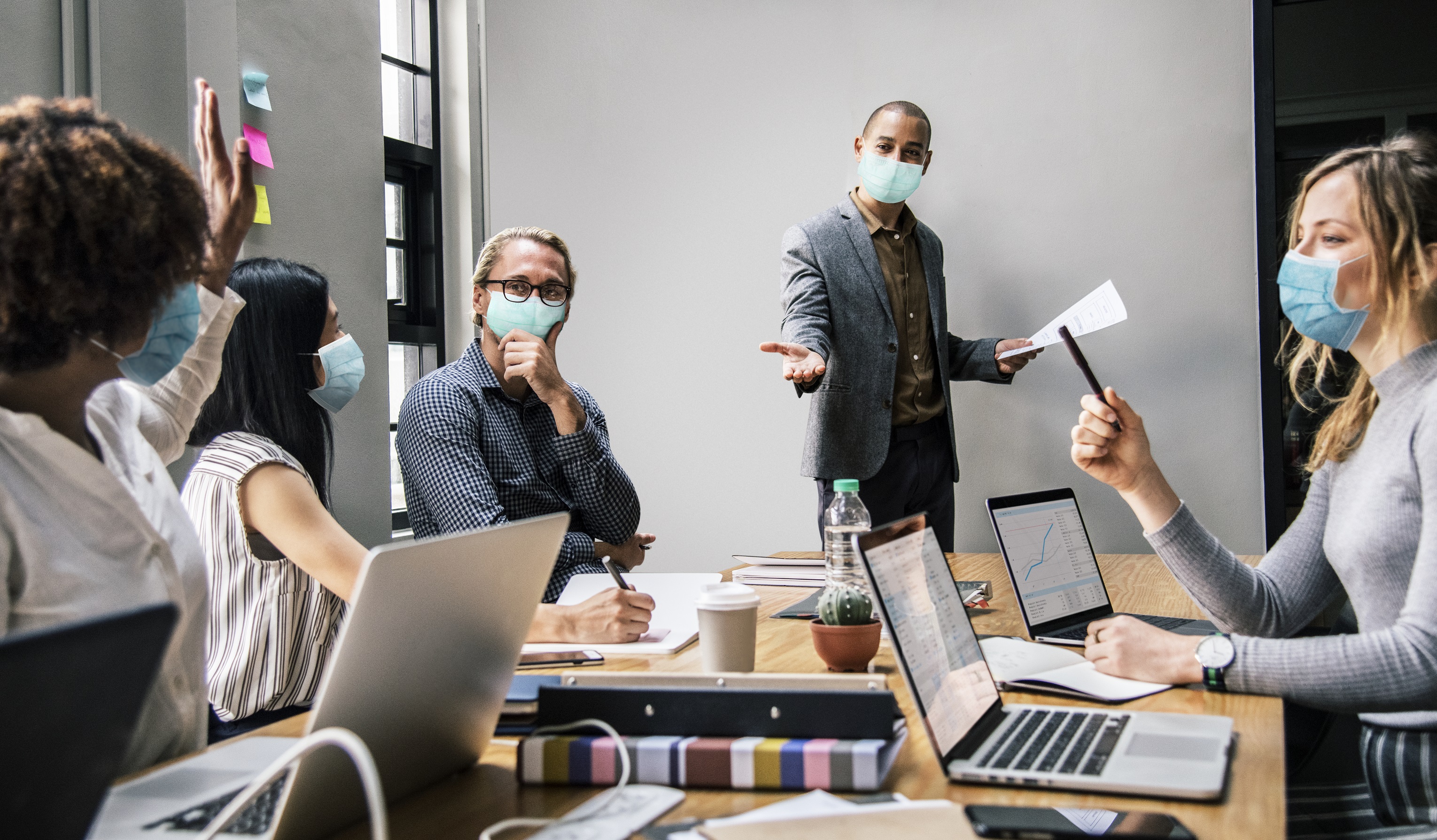 business-people-wearing-masks-in-coronavirus-meeting-the-new-normal