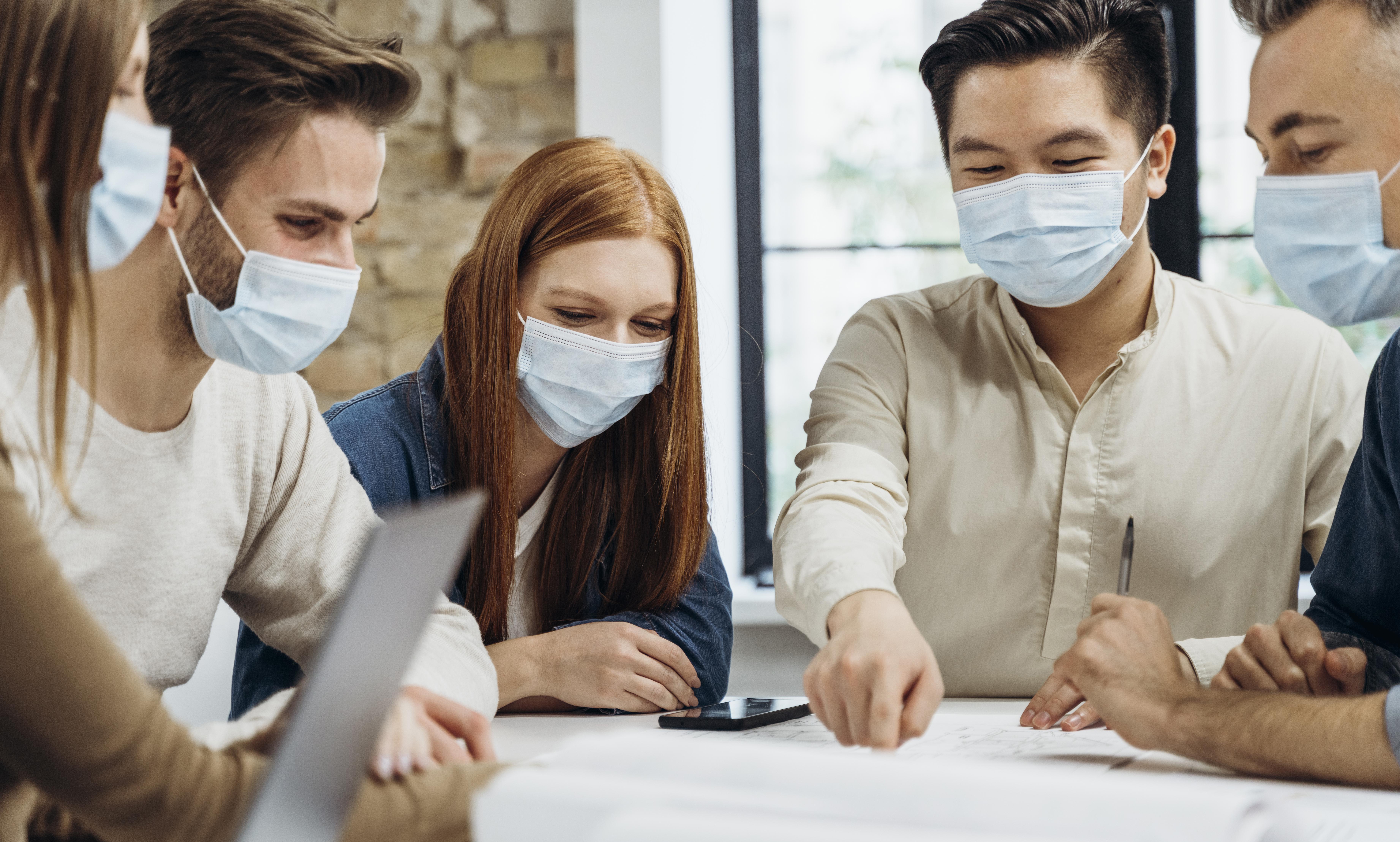 business-people-wearing-medical-masks-while-discussing-a-project