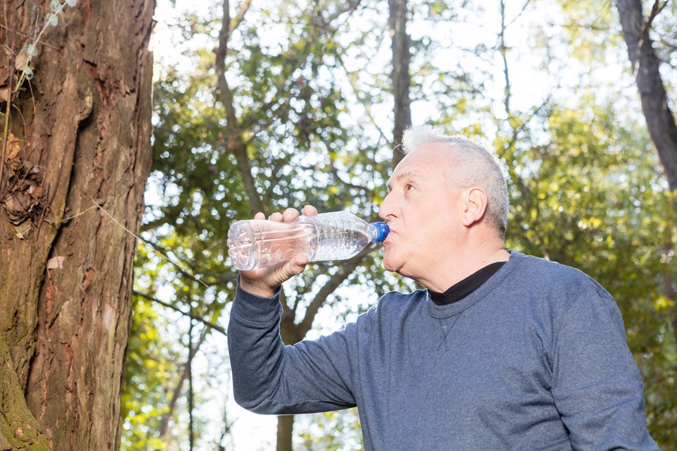 close-up-thirsty-man-drinking-water-after-exercising