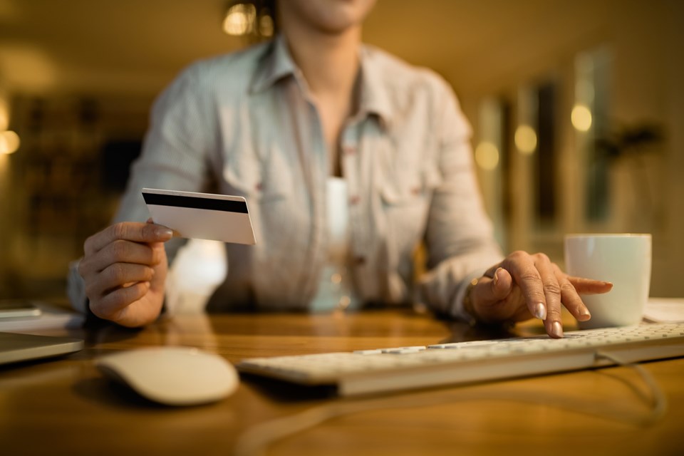 closeup-woman-using-computer-credit-card-online-banking-evening-home (1)