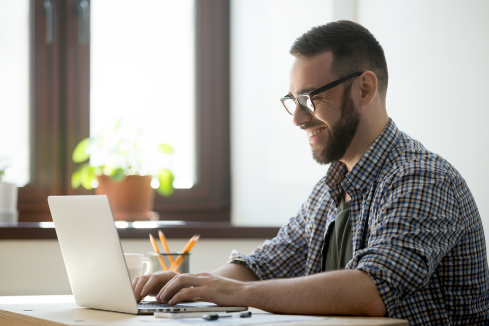 happy-male-writing-positive-mail-to-client-2