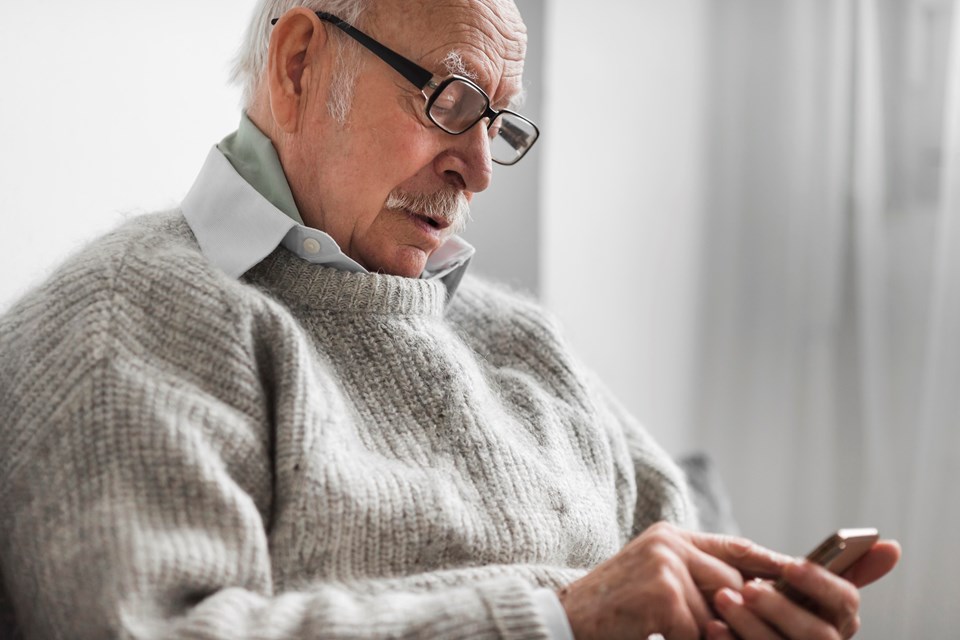 side-view-old-man-nursing-home-using-smartphone