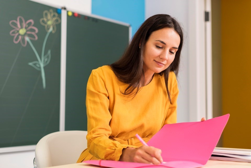 smiley-teacher-taking-notes-1-1-1