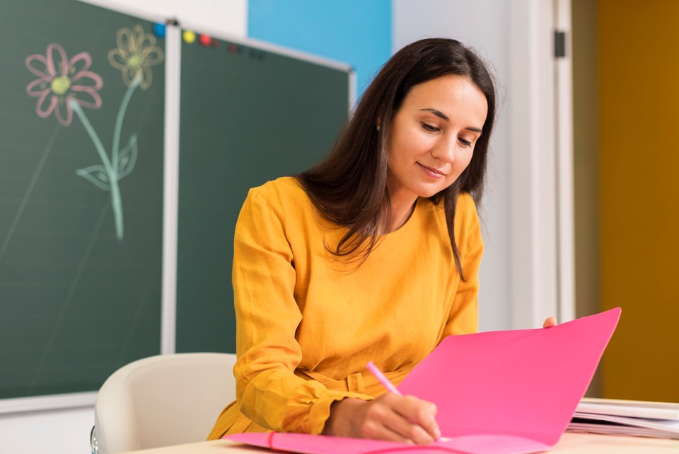 smiley-teacher-taking-notes
