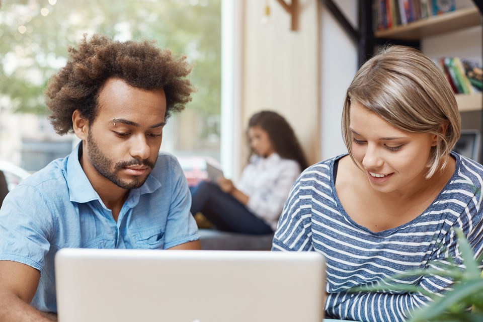 two-young-freelance-designers-sitting-co-working-space-looking-laptop-monitor-searching-new-ideas-furniture-designers-pair-young-cheerful-people-smiling-spending-morning-libra (1)