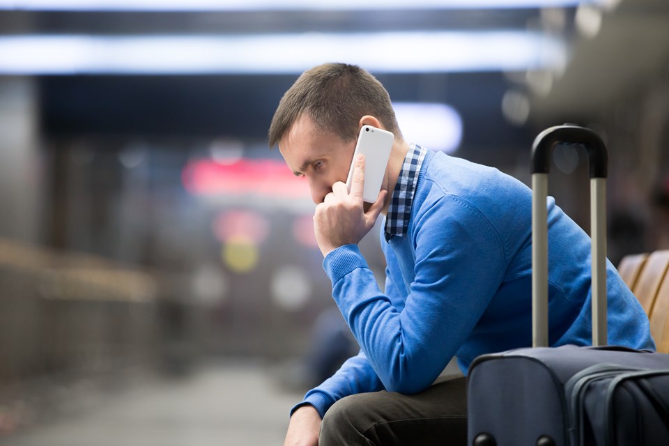 young-man-on-phone-at-airport (1)